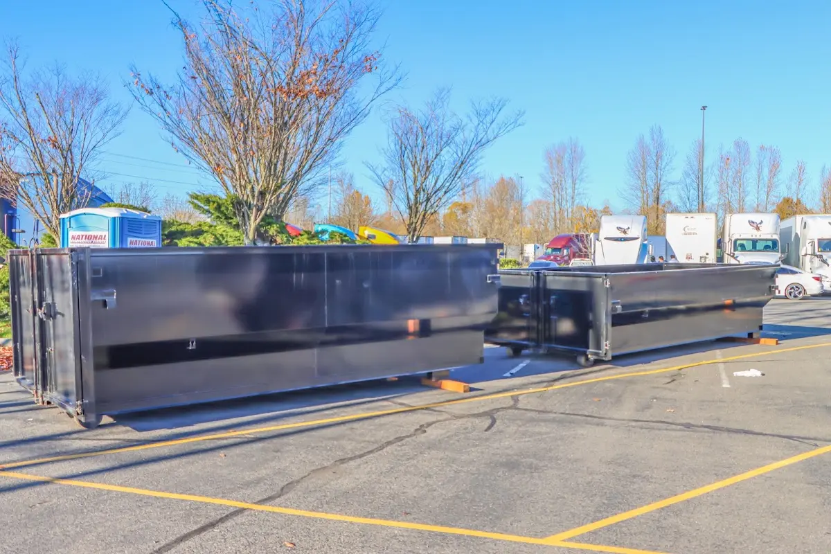 Professional dumpster rental service with roll-off container on residential driveway in Mango